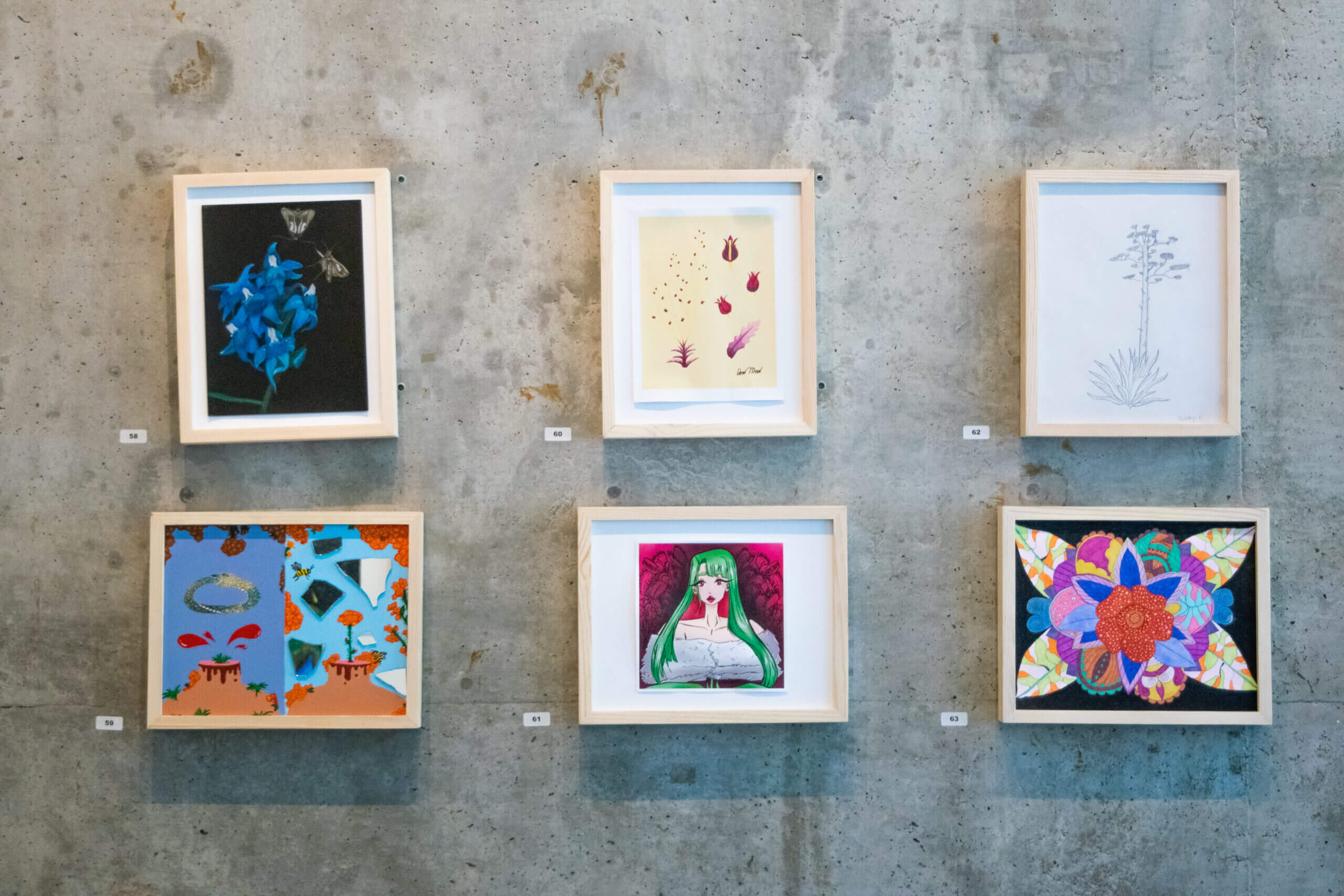 6 framed artworks against a gray gallery wall